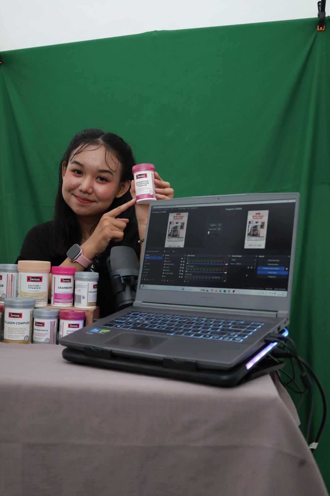 a person wearing headphones and sitting at a desk with a microphone